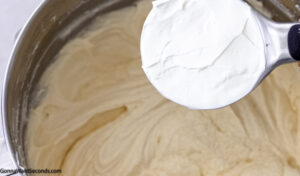 How to make blueberry pound cake, adding sour cream to the batter