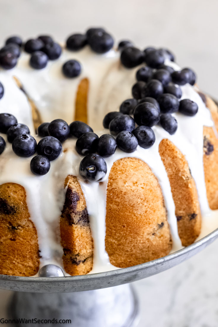 blueberry pound cake with glaze topped with fresh blueberries