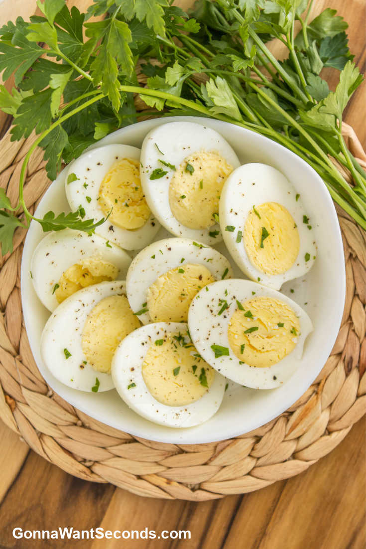 air fryer hard boiled eggs sliced and placed in a shallow bowl, top shot