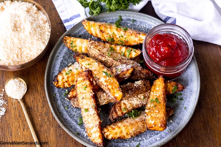 air fryer potato wedges with ketchup on the side, top shot