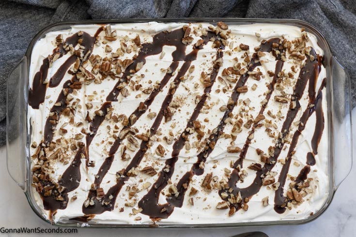 How to make easy chocolate delight recipe, adding the crushed pecans and chocolate syrup