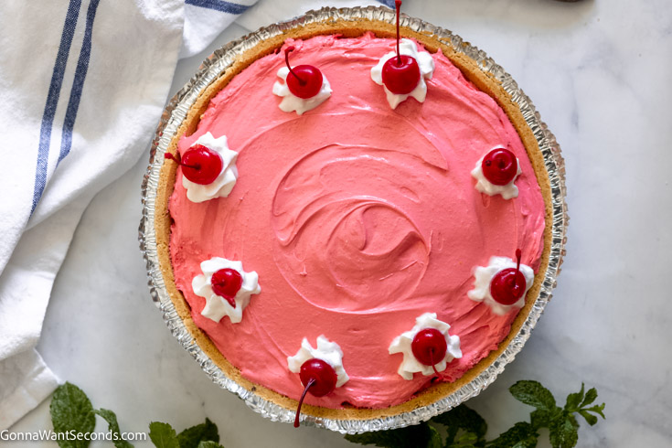 southern kool-aid pie topped with whipped cream and cherry, top shot