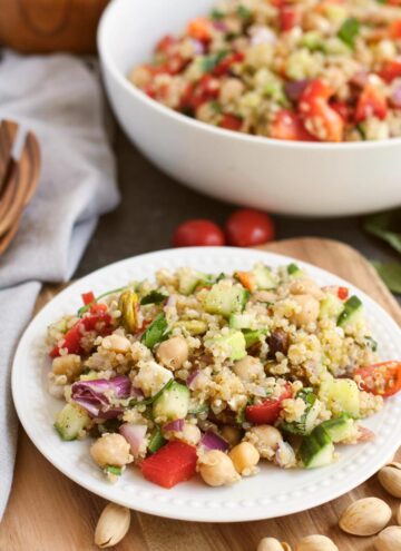 summer quinoa salad on a plate and in a bowl full of salad