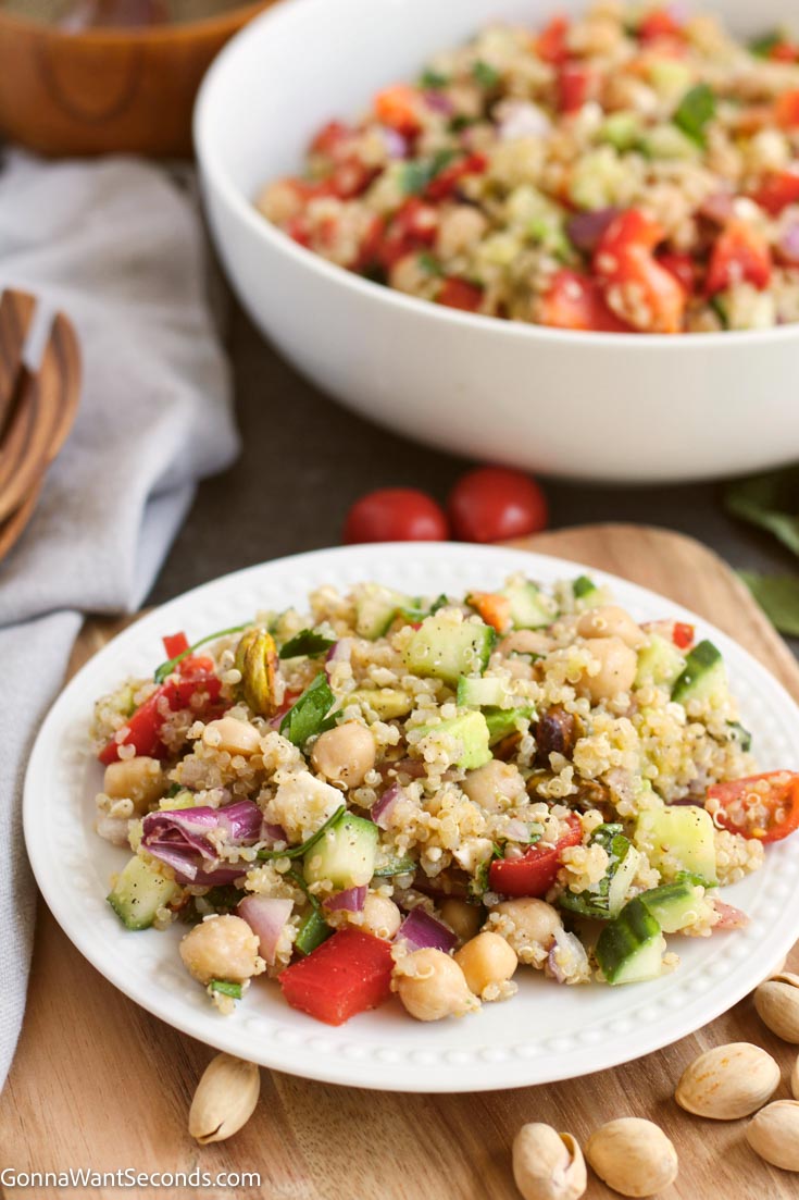 summer quinoa salad on a plate and in a bowl full of salad 