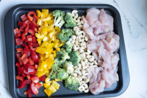 How to make sheet pan cashew chicken, place ingredients on the sheet pan