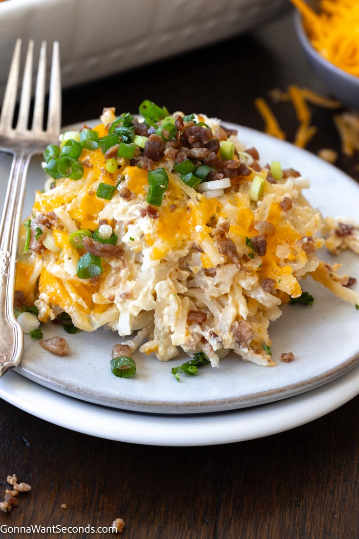 loaded crack potatoes on a plate with fork on the side