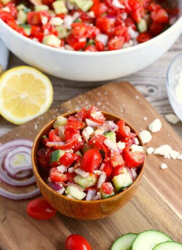 cucumber tomato feta salad in a wooden bowl
