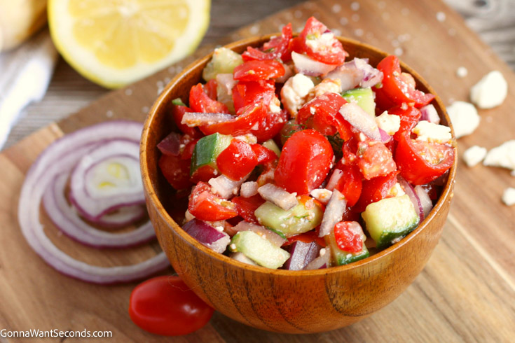 cucumber tomato feta salad with dill in a wooden bowl