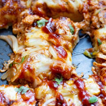 sheet pan BBQ chicken pizza drizzled with BBQ sauce on top