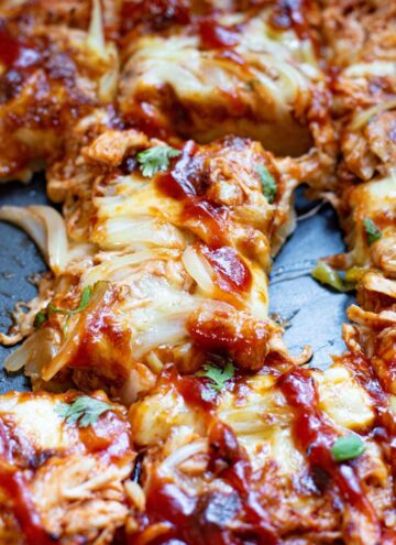 sheet pan BBQ chicken pizza drizzled with BBQ sauce on top