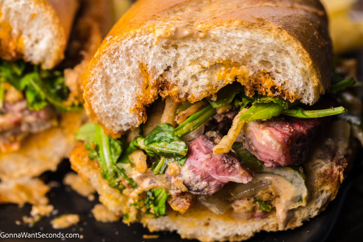 steak sandwich with arugula close up