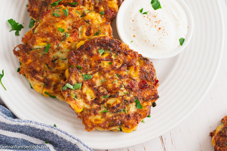 corn and zucchini fritters with dipping sauce on the side