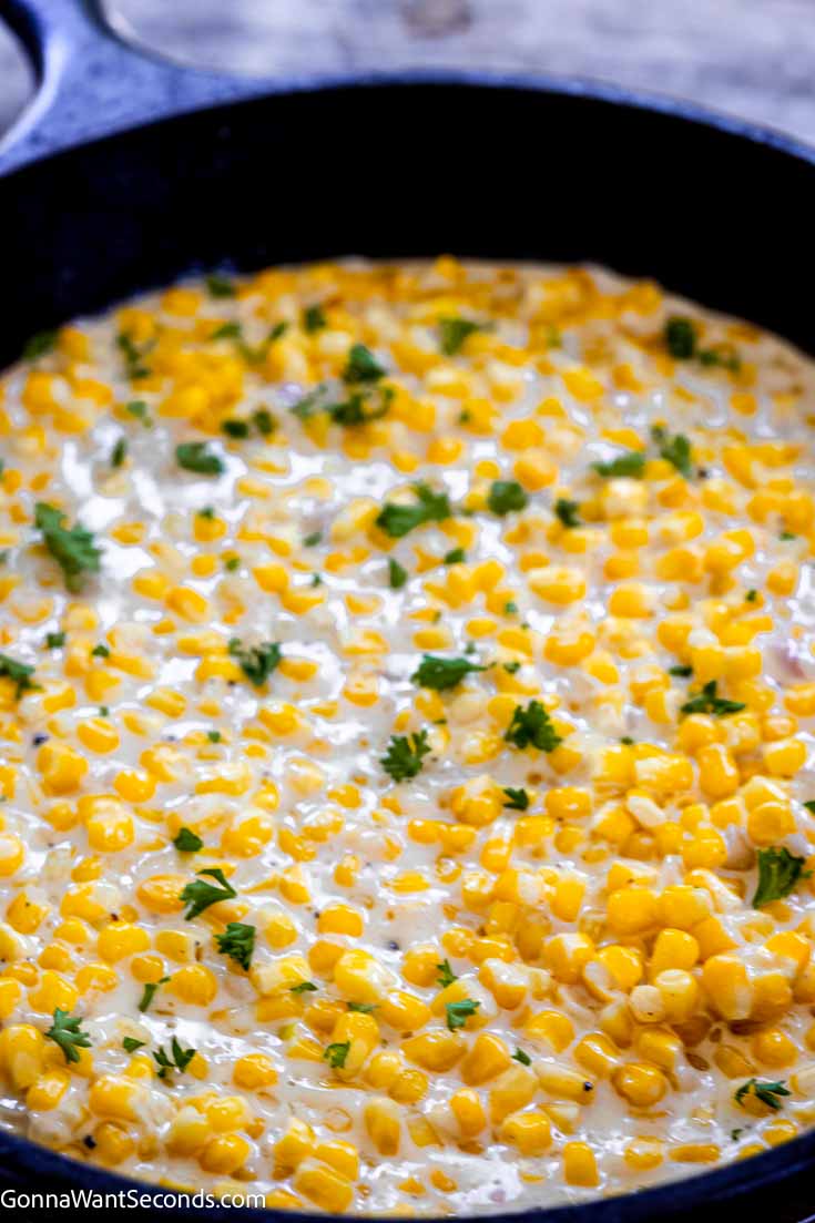 Our honey butter skillet corn is a sweet and savory side dish that's easy to make and your family will ask for on repeat!!! #buttercorn #skilletcorn honey butter corn in a cast iron skillet