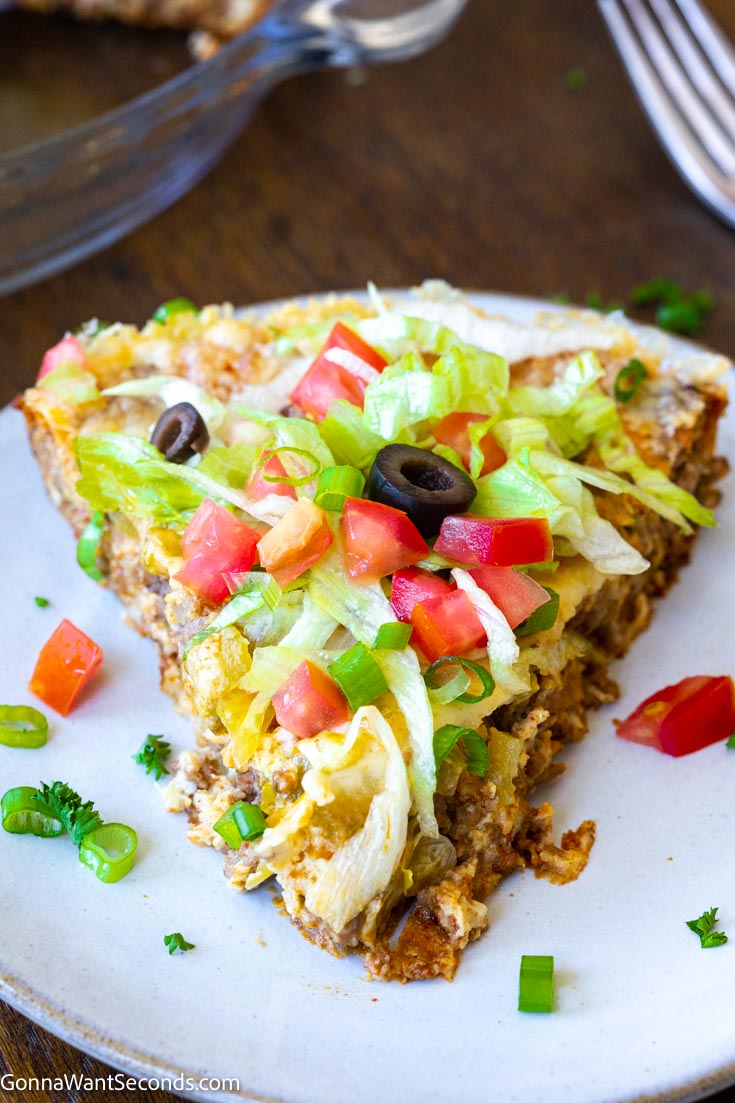 A slice of Bisquick Impossible Taco Pie with toppings