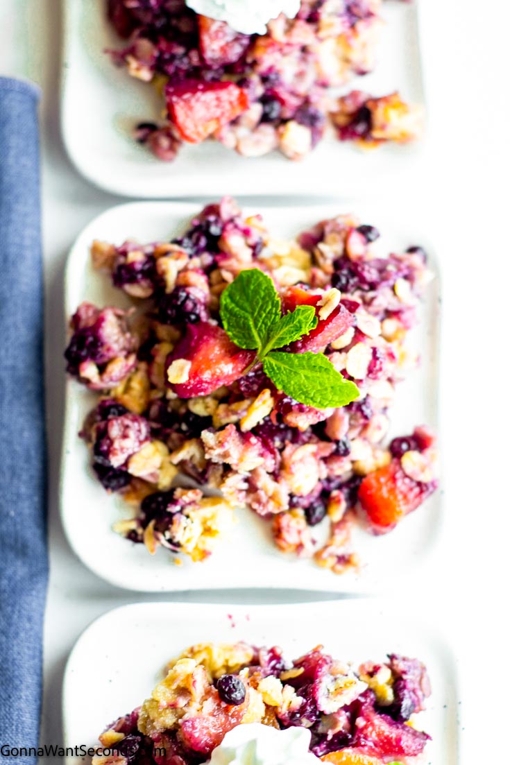 peach & blueberry crisp on a square plate, top shot