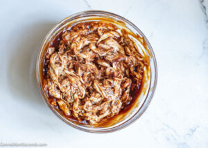 How to make BBQ Chicken Quesadilla , mixing chicken and bbq sauce