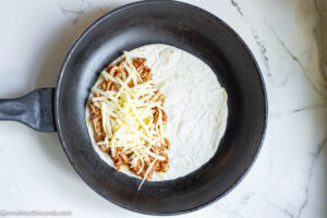 How to make chicken quesadilla with bbq sauce , topping cheese over chicken