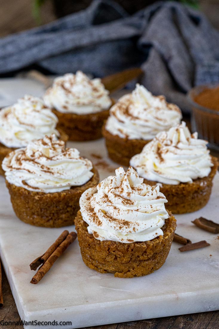 irresistible pumpkin pie cupcakes with whipped cream on top