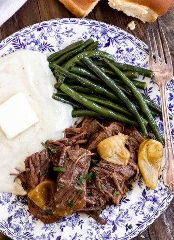 instant pot mississippi pot roast with green beans and mashed potatoes on a plate