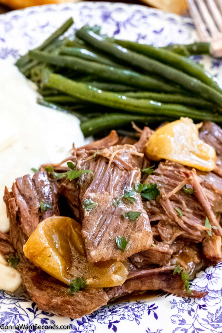 mississippi roast instant pot with green beans and mashed potatoes on a plate 
