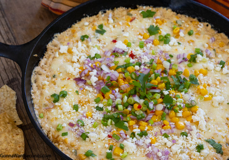 mexican street corn dip in a cast iron skillet
