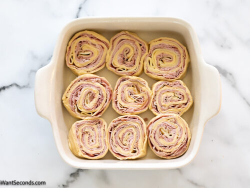how to make ham and cheese pinwheels , arrange in the baking dish