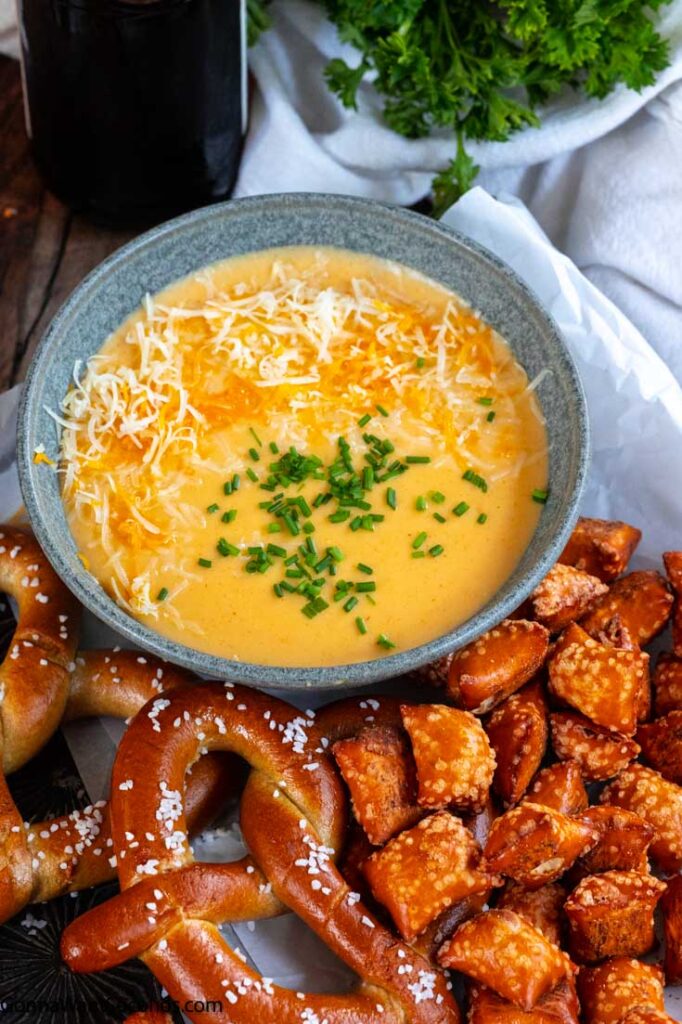 beer cheese dip without cream cheese in a bowl with pretzels on the side