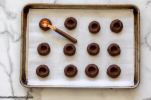 how to make double chocolate thumbprint cookies , indenting measurng spoon to cookie