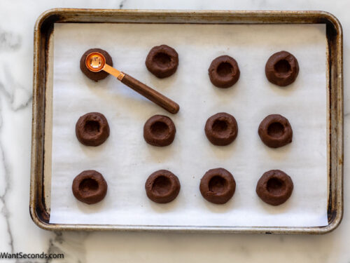 how to make double chocolate thumbprint cookies , indenting measurng spoon to cookie