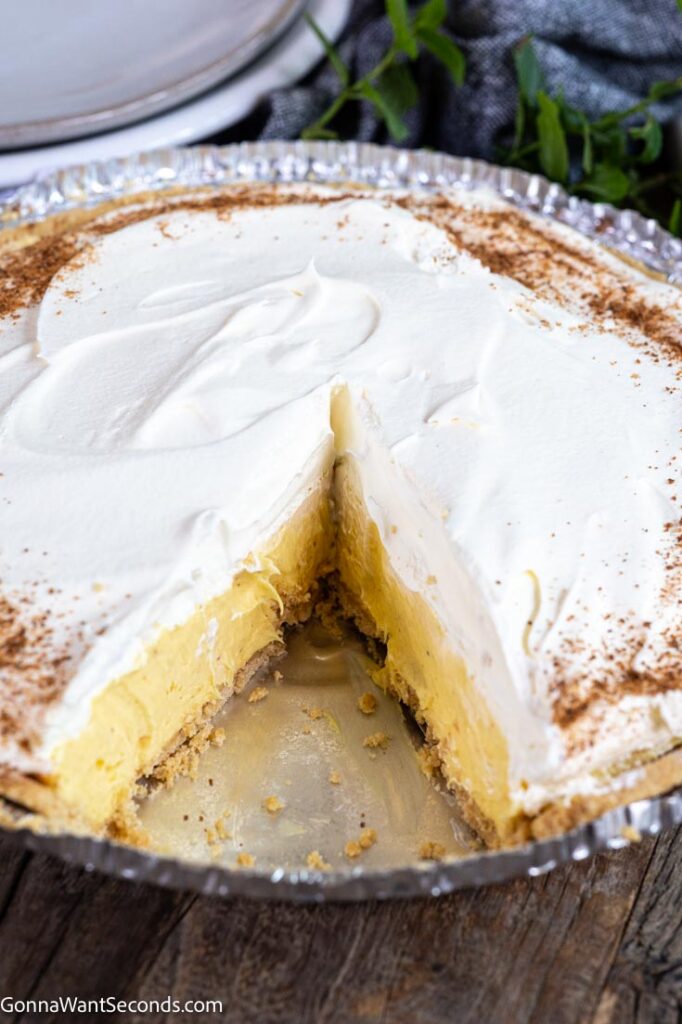 A whole christmas eggnog pie with a missing slice