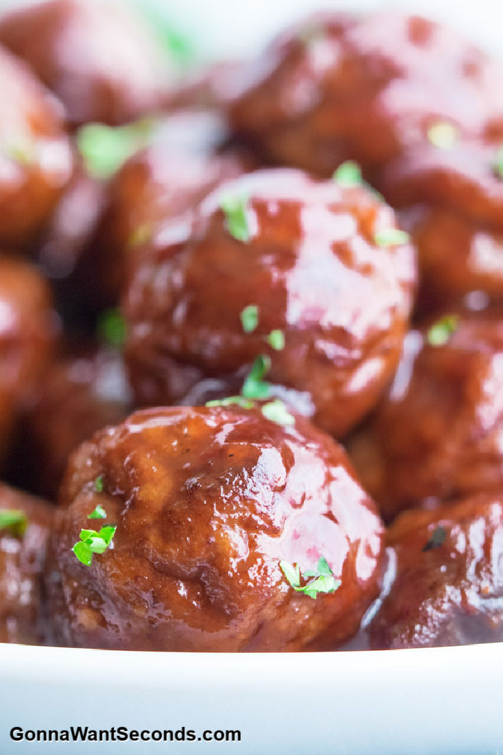 grape jelly meatballs crockpot in a shallow white bowl