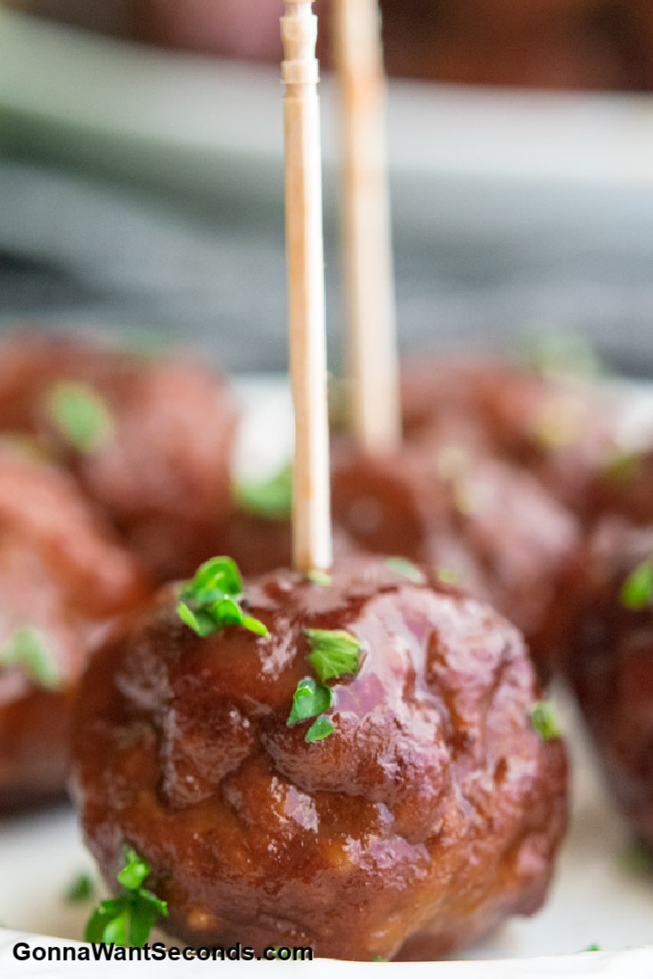 welch's grape jelly meatballs with toothpicks, sprinkled with chopped parsley