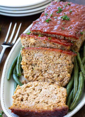 stove top stuffing meatloaf on a serving plate with beans on the side
