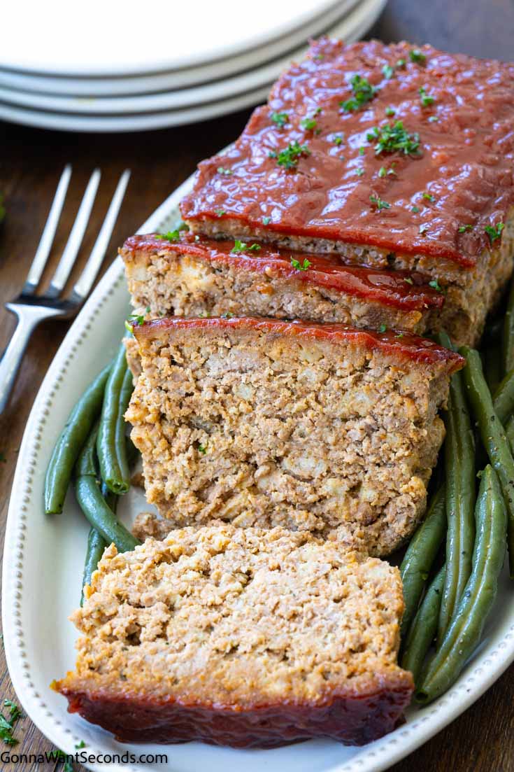 stove top stuffing meatloaf on a serving plate with beans on the side