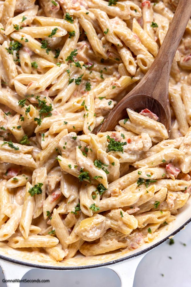 Cajun Chicken Alfredo with wooden ladle in a pot
