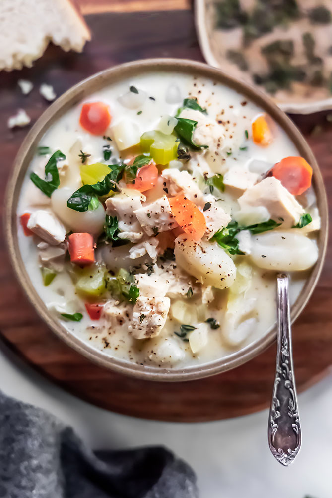 healthy chicken gnocchi soup in a bowl, top shot