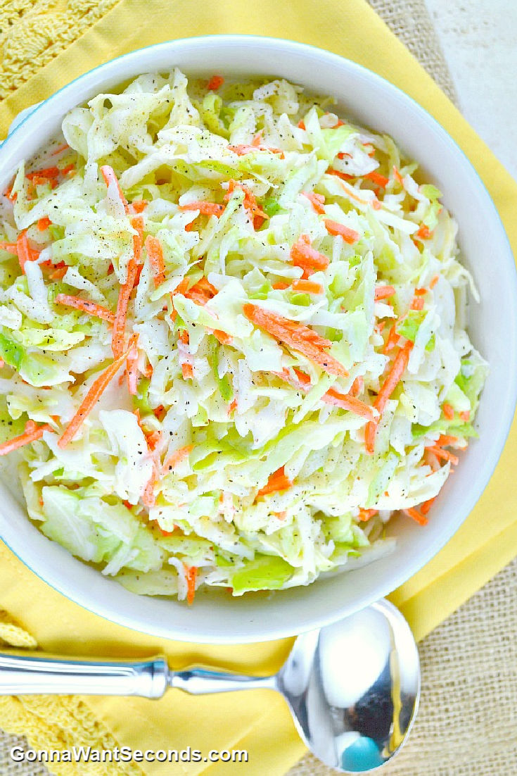 copycat kfc coleslaw in a bowl with serving spoon on the side