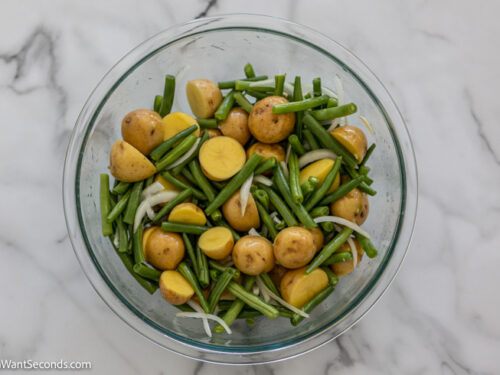 how to make sausage green bean and potato casserole , toss the green beans and potato