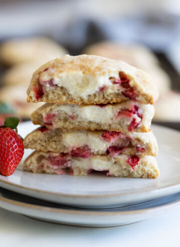 strawberry cheesecake cookies cut in half stack on top of each other