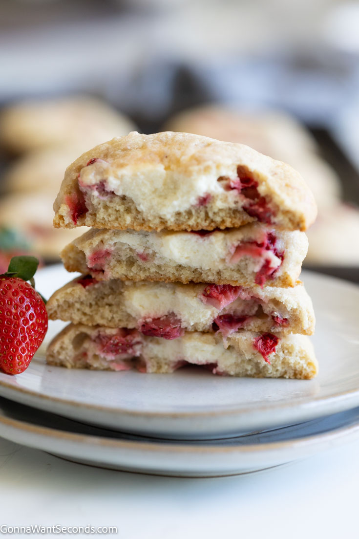 strawberry cheesecake cookies cut in half stack on top of each other