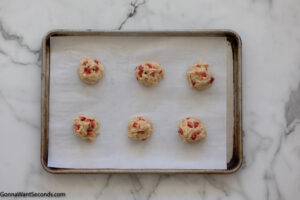 Step 7 how to make strawberry cheesecake cookies, Assembly. Place six scoops on each of the two parchment-lined baking sheets.