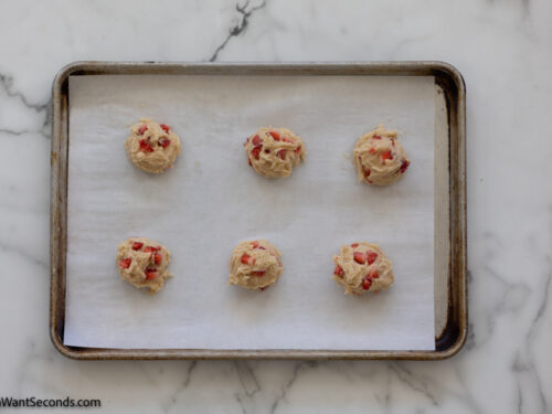 Step 7 how to make strawberry cheesecake cookies, Assembly. Place six scoops on each of the two parchment-lined baking sheets.