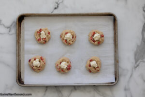 Step 9 how to make strawberry cheesecake cookies, Scoop the frozen cream cheese into the indent.