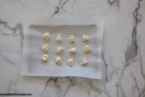 Step 2 how to make strawberry cheesecake cookies, Use a cookie scoop to portion out 12 equal portions of the cream cheese mixture onto a parchment-lined small baking sheet. Freeze.