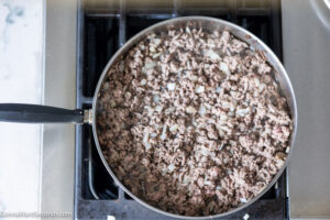 how to make bisquick taco casserole step 2, Crumble the beef and cook until there's no longer pink.