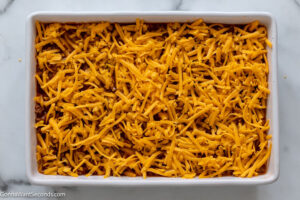 how to make bisquick taco bake step 5, Sprinkle cheese over the beef mixture.