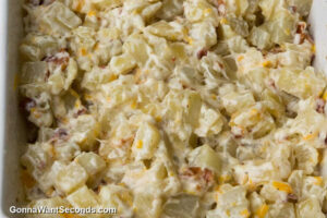 how to make hidden valley ranch potatoes with bacon step 3, Bake, then mix. Add half of the cheese and bacon.