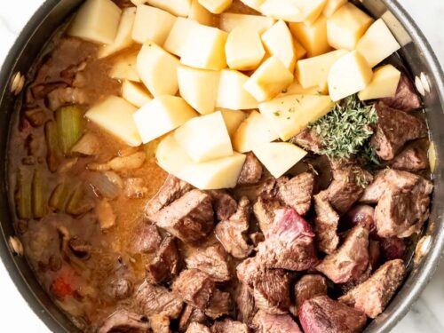 How to make beef and guinness stew, Return the browned beef, add the potatoes and thyme.