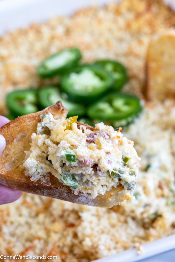 bread scooping jalapeno popper dip with fresh jalapenos