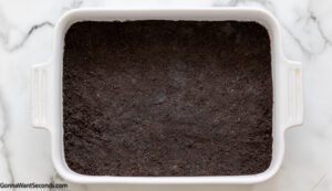 how to make oreo delight pudding recipe step 2, Press the crumb mixture into the bottom of the prepared baking dish. Refrigerate.